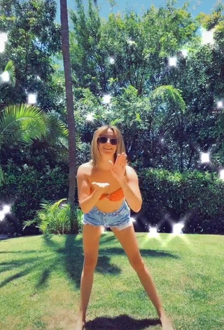 1. Desirable Ashley Tisdale in Orange Bikini Top