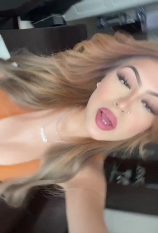 Desiree Montoya Shows Cleavage in Erotic Orange Crop Top