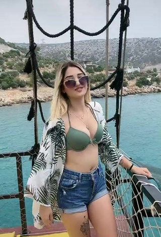 3. Sexy Eda Aslankoç Shows Cleavage in Olive Bikini Top on a Boat