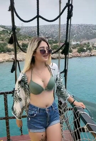 4. Sexy Eda Aslankoç Shows Cleavage in Olive Bikini Top on a Boat