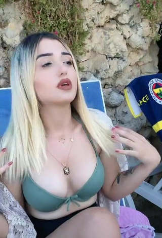 3. Hot Eda Aslankoç Shows Cleavage in Olive Bikini Top