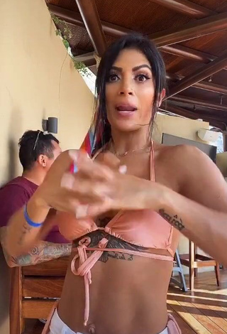 Erotic Kimberly Flores Shows Cleavage in Peach Bikini Top