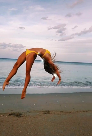 4. Breathtaking Olivia Dunne in Yellow Bikini at the Beach while doing Fitness Exercises