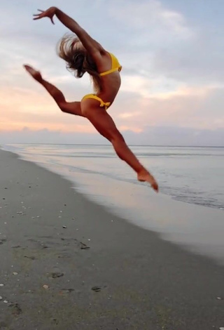 4. Hot Olivia Dunne in Yellow Bikini at the Beach while doing Fitness Exercises