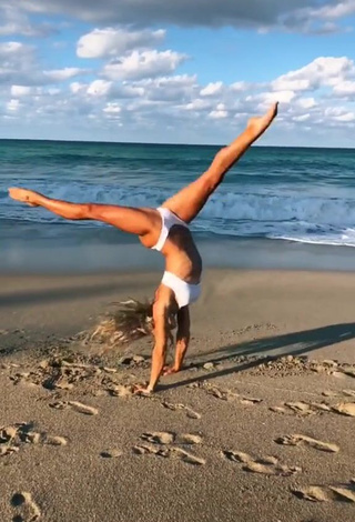 Lovely Olivia Dunne in White Bikini at the Beach while doing Fitness Exercises