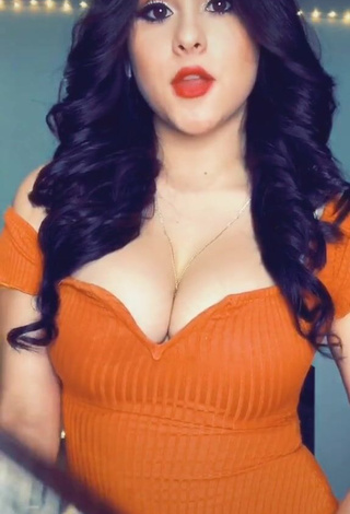 Cute Ónice Flores Shows Cleavage in Orange Dress