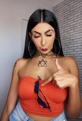 Hot Sil Shows Cleavage in Electric Orange Tube Top