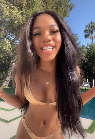 Pretty Teala Dunn Shows Cleavage in Golden Bikini at the Swimming Pool