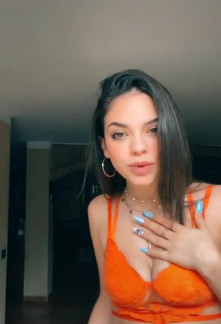 Hot Giulia Paglianiti Shows Cleavage in Electric Orange Bra