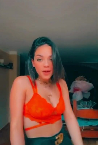 4. Sexy Giulia Paglianiti Shows Cleavage in Electric Orange Bra