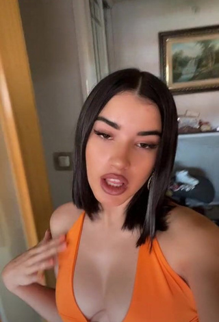 Erotic Kiara Brunett Shows Cleavage in Orange Crop Top