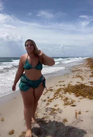 Erotic Sam Paige Shows Cleavage in Green Bikini at the Beach