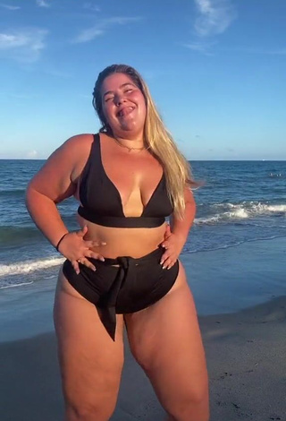 Seductive Sam Paige Shows Cleavage in Black Bikini at the Beach