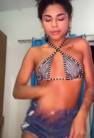 3. Seductive Angel Oficial Shows Cleavage in Striped Bikini Top (Side Boob)