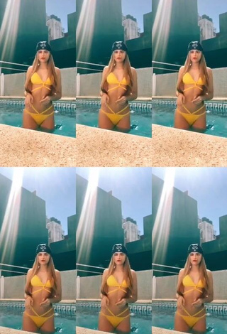 Hot Maga Seggio Shows Cleavage in Yellow Bikini at the Swimming Pool