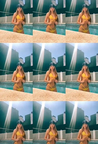 3. Hot Maga Seggio Shows Cleavage in Yellow Bikini at the Swimming Pool