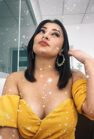 3. Sexy Milagro Flores Shows Cleavage in Yellow Dress