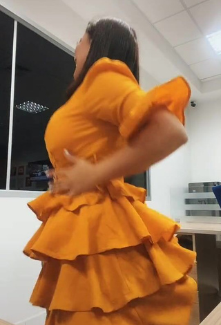 Hot Milagro Flores Shows Cleavage in Orange Dress