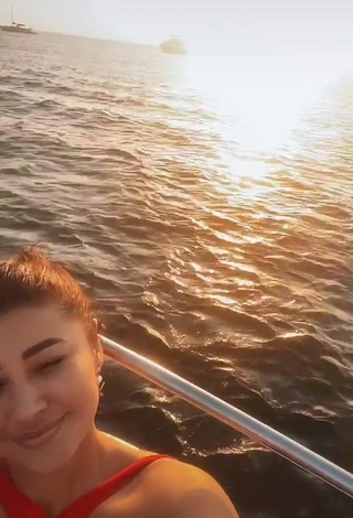 Hot Milagro Flores Shows Cleavage in Red Swimsuit on a Boat