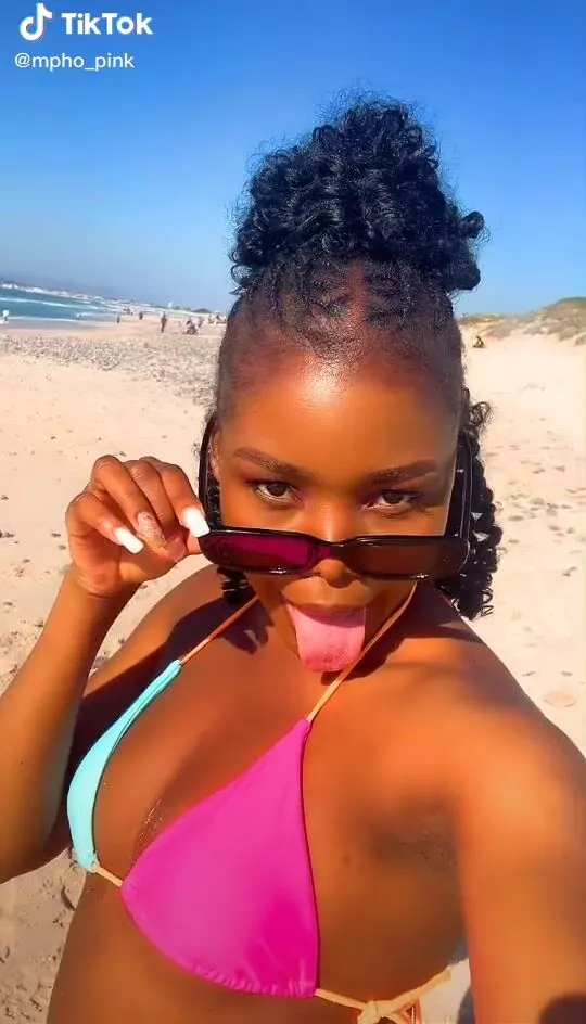 Hot mpho pink Shows Cleavage in Bikini Top at the Beach
