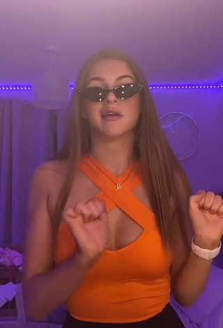 3. Hottie Sophie Aspin Shows Cleavage in Orange Top