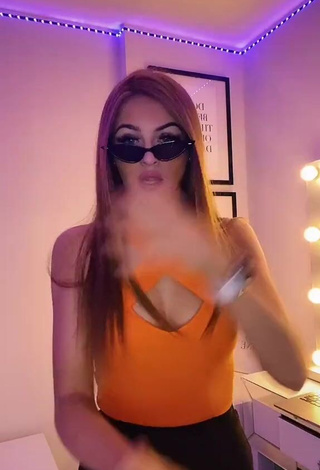 Hot Sophie Aspin Shows Cleavage in Orange Top