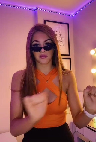 3. Hot Sophie Aspin Shows Cleavage in Orange Top