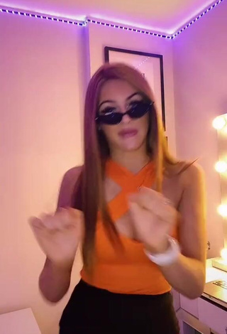 4. Hot Sophie Aspin Shows Cleavage in Orange Top