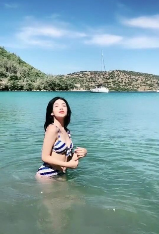 Hot Sude Naz Bulut Shows Cleavage in Striped Bikini in the Sea