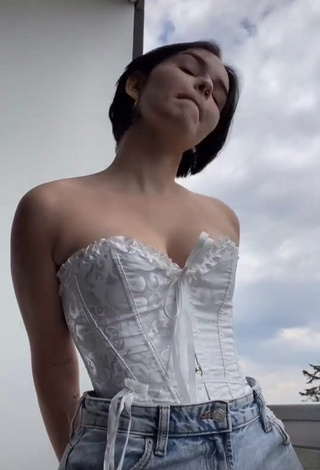 1. Sexy Angelique Shows Cleavage in White Corset on the Balcony