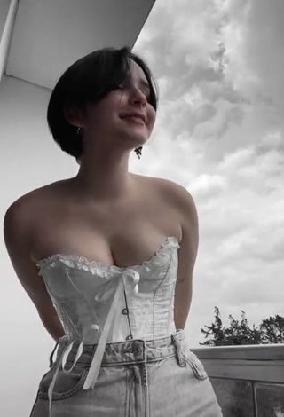 Hot Angelique Shows Cleavage in White Corset on the Balcony