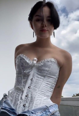 1. Desirable Angelique Shows Cleavage in White Corset on the Balcony