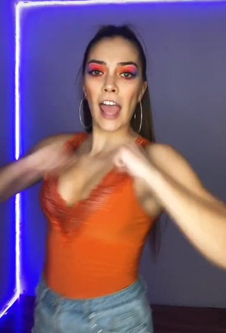 Sexy Azul Granton Shows Cleavage in Orange Top