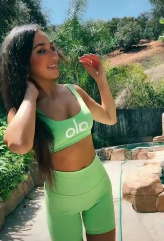 1. Gorgeous Iris Shows Cleavage in Alluring Green Crop Top