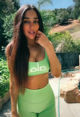 4. Gorgeous Iris Shows Cleavage in Alluring Green Crop Top