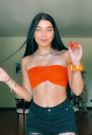 1. Hot Sofia Crisafulli Shows Cleavage in Orange Tube Top