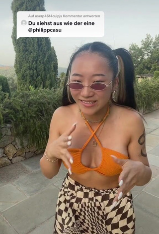 Hot Xinting Wang Shows Cleavage in Orange Bikini Top