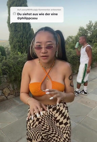 3. Hot Xinting Wang Shows Cleavage in Orange Bikini Top