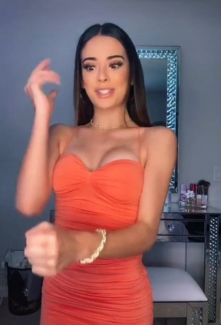 Desirable Lauren Kettering Shows Cleavage in Orange Dress