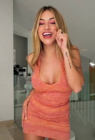 1. Fine Abril Cols Shows Cleavage in Sweet Orange Dress