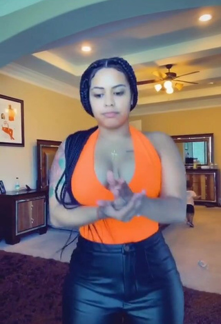 1. Sexy Carmen Pritchett Shows Cleavage in Electric Orange Top